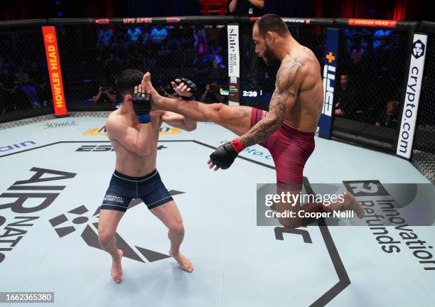 Jean Silva of Brazil kicks Kevin Vallejos of Argentina in a featherweight fight during Dana White's Contender Series season seven, week five at UFC...
