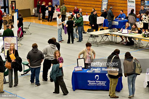 Job seekers mingle with employers during a job fair at Illinois Valley Community College in Oglesby, Illinois, U.S., on Wednesday, April 10, 2013....