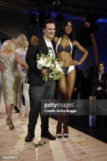 Guido Maria Kretschmer and a model attend the Guido Maria Kretschmer For eBay Collection Launch at Label 2 on April 10, 2013 in Berlin, Germany.