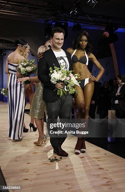 Guido Maria Kretschmer and a model attend the Guido Maria Kretschmer For eBay Collection Launch at Label 2 on April 10, 2013 in Berlin, Germany.