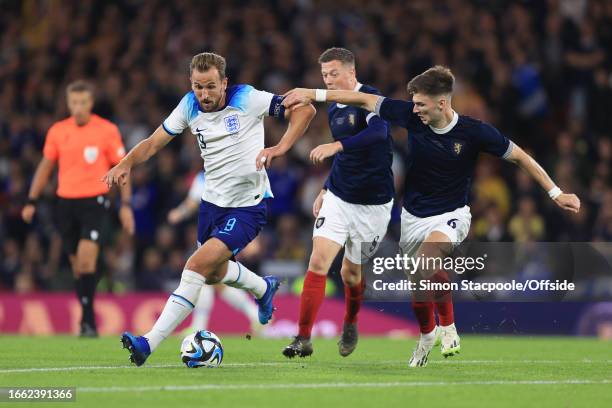 Harry Kane of England battles with Kieran Tierney of Scotland and Callum McGregor of Scotland during the 150th Anniversary Heritage Match between...