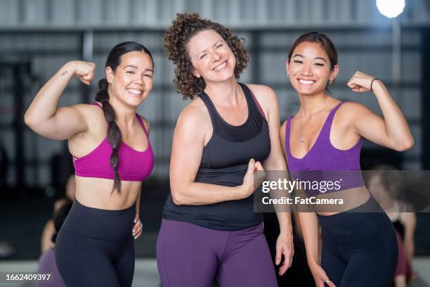 feeling strong - group of people flexing biceps stock pictures, royalty-free photos & images