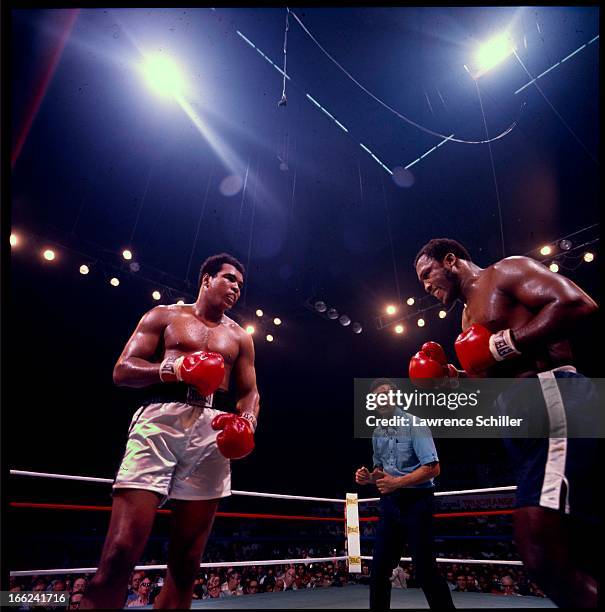 American boxers Muhammad Ali and Joe Frazier face off in the ring at Araneta Coliseum, Quezon City, Philippines, October 1, 1975. Referee Carlos...