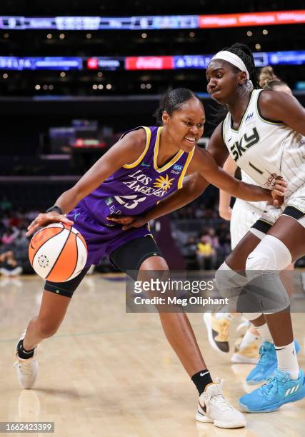 Forward Azura Stevens of the Los Angeles Sparks handles the ball in the first half defended by center Elizabeth Williams of the Chicago Sky at...