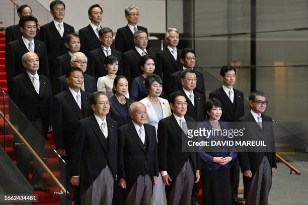 Japanese Prime Minister Fumio Kishida poses with his new cabinet at his official residence in Tokyo on September 13, 2023. Kishida named new foreign...