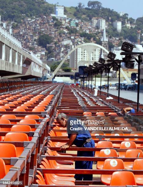 Worker adjusts seats at the samba school 25 February, 2003 in Rio de Janeiro in Brazil's annual Carnival celebrations. Fourteen samba schools will...