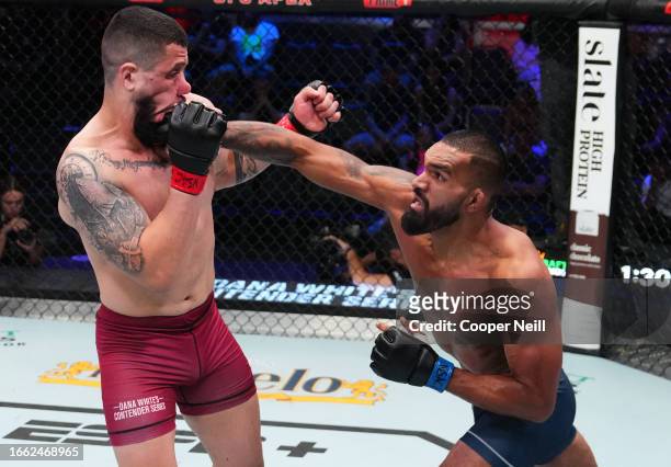 Brendson Ribeiro of Brazil punches Bruno Lopes of Brazil in a light heavyweight fight during Dana White's Contender Series season seven, week five at...