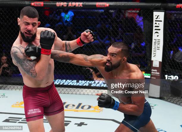 Brendson Ribeiro of Brazil punches Bruno Lopes of Brazil in a light heavyweight fight during Dana White's Contender Series season seven, week five at...