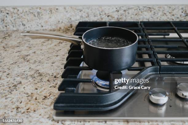 water boils on gas cooktop - boiling stock pictures, royalty-free photos & images