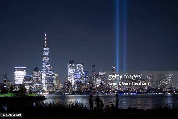 The annual Tribute in Light is illuminated above the skyline of lower Manhattan and One World Trade Center as it is set up to mark the 22nd...