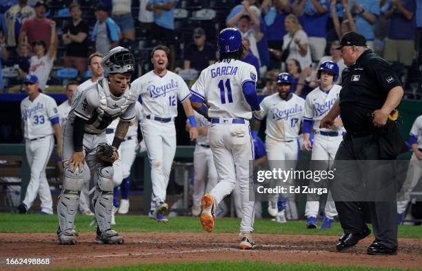 Maikel Garcia of the Kansas City Royals crosses home as he scores on a walk-off balk in the ninth inning against the Chicago White Sox at Kauffman...