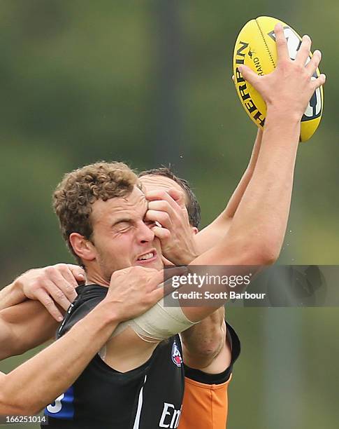 Jarrod Witts is tackled by Ben Hudson during a Collingwood AFL training session at the launch of the Collingwood Magpies new AFL training ground at...
