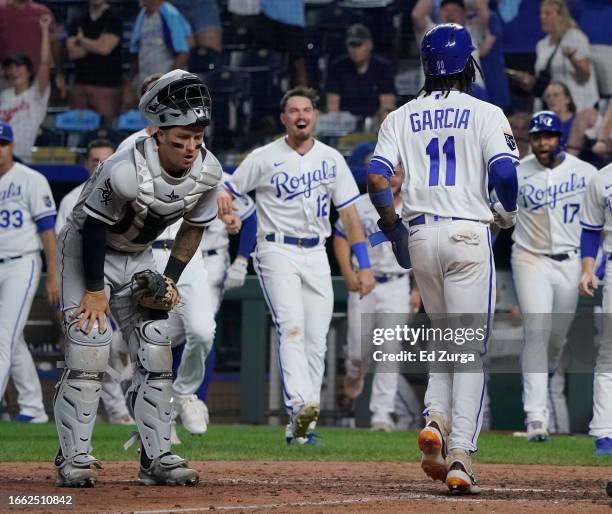 Maikel Garcia of the Kansas City Royals crosses home and scores as Korey Lee of the Chicago White Sox reacts to a walk-off balk in the ninth inning...