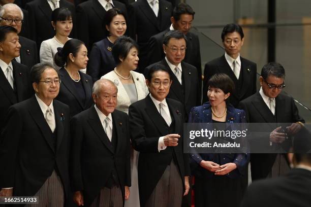 Japanese Prime Minister Fumio Kishida poses with new cabinet members at his official residence after new cabinet reshuffle, keeping in place some...