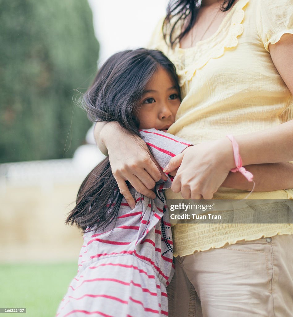 Mother and daughter huggin outdoor