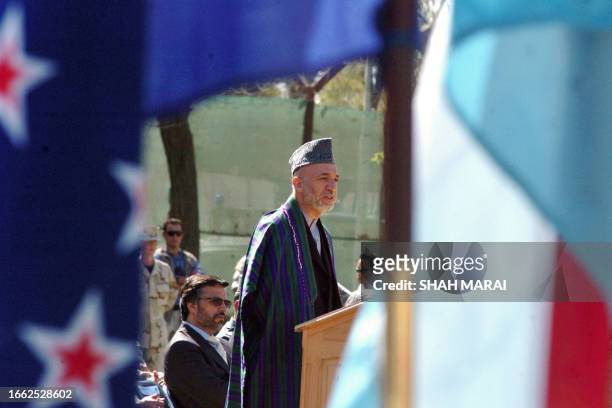 Afghan President Hamid Karzai delivers a speech during a transfer of command ceremony at NATO'S International Security Assistance Force headquarters...