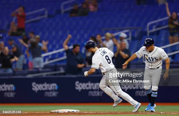 Brandon Lowe of the Tampa Bay Rays celebrates a walk off three run home run in the 11th inning during a game against the Boston Red Sox at Tropicana...