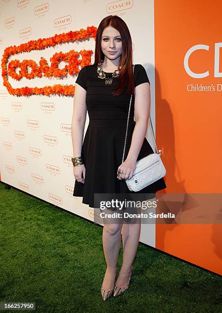 Actress Michelle Trachtenberg carrying Coach attends Coach's 3rd Annual Evening of Cocktails and Shopping to Benefit the Children's Defense Fund...