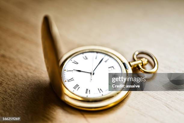 gold vintage pocket watch on wood table - roman numeral ten stock pictures, royalty-free photos & images