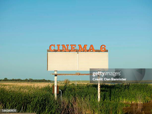 abandoned drive-in movie sign in field - drive in cinema stock pictures, royalty-free photos & images