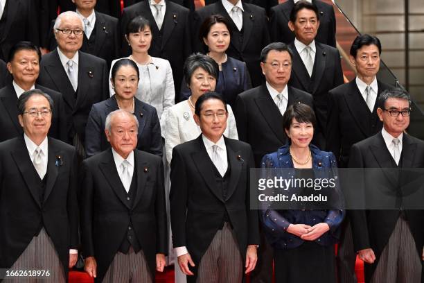 Japanese Prime Minister Fumio Kishida poses with new cabinet members at his official residence after new cabinet reshuffle, keeping in place some...