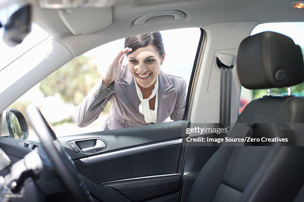 Woman examining new car