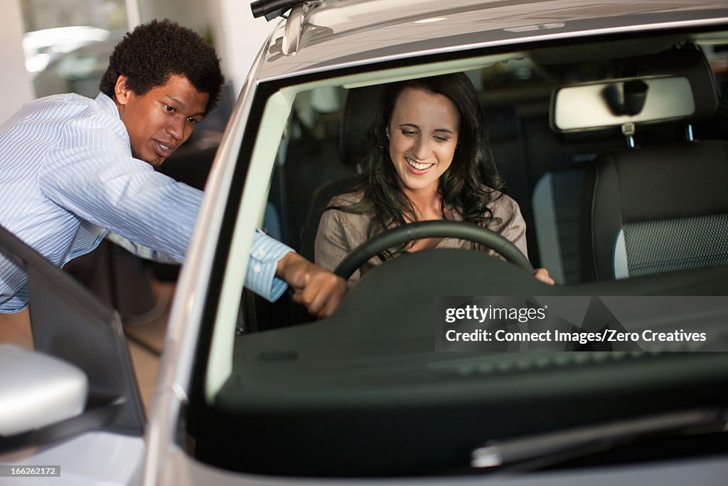 Salesman showing woman new car