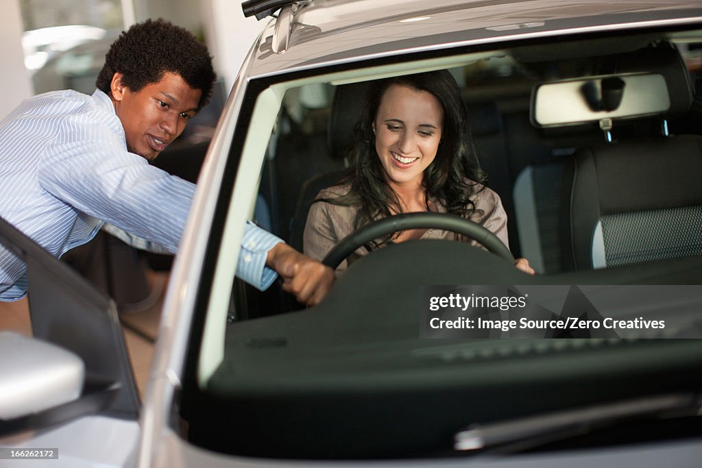 Salesman showing woman new car