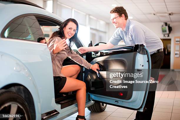 woman getting in car at dealership - gesticulando - fotografias e filmes do acervo