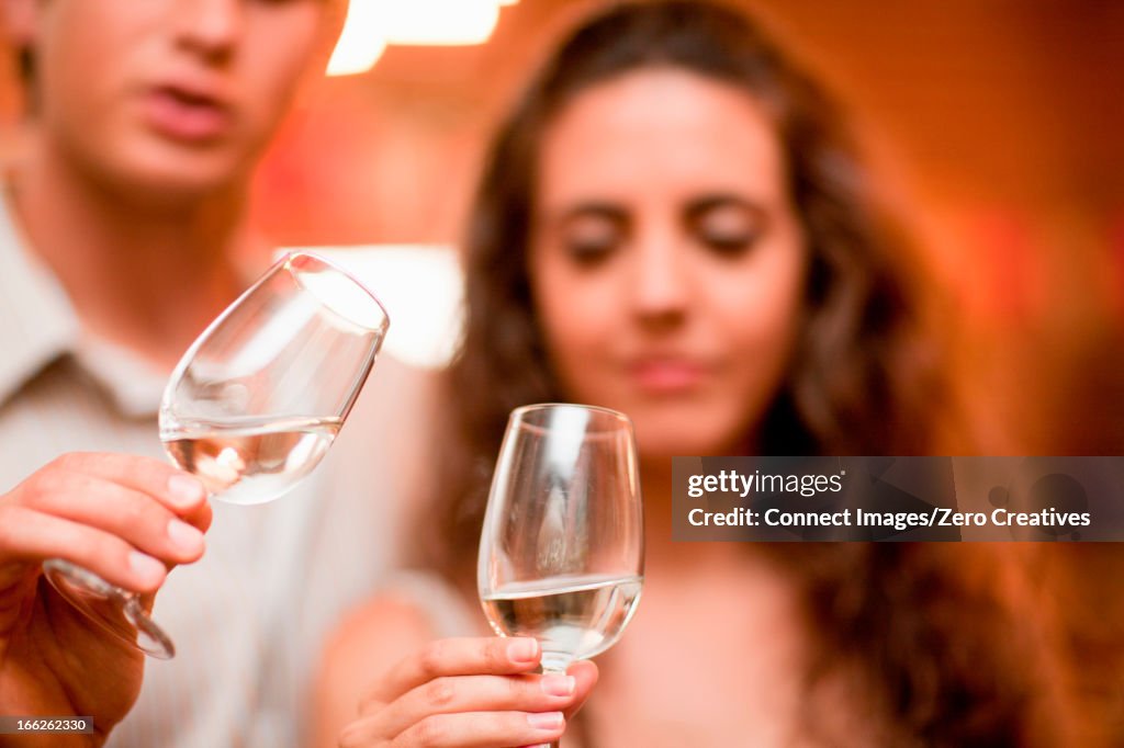 Couple tasting wine in grocery