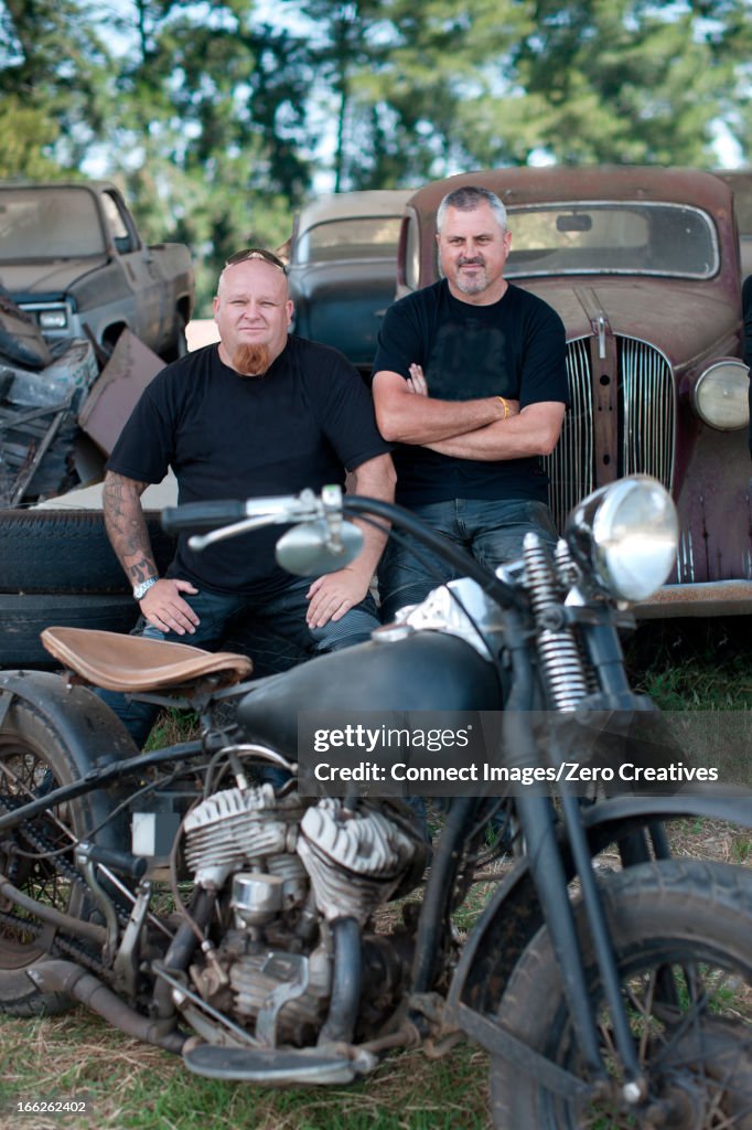 Men sitting with motorcycle