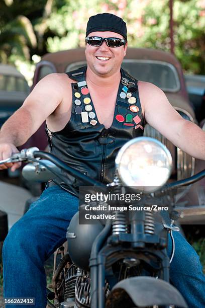 man in leather vest on motorcycle - waistcoat stock-fotos und bilder