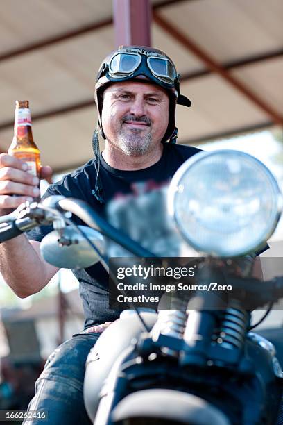 man drinking beer on motorcycle - beer helmet stock pictures, royalty-free photos & images