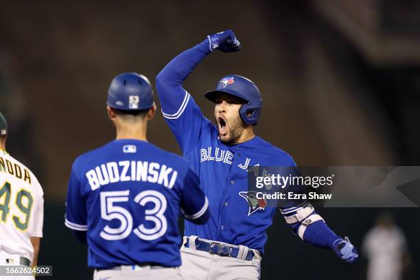 George Springer of the Toronto Blue Jays reacts after he hit a single that scored two runs against the Oakland Athletics in the seventh inning at...