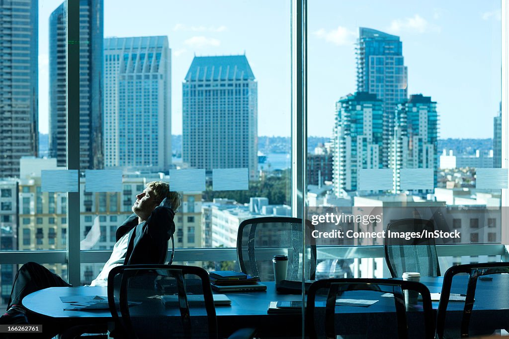 Businessman relaxing at desk in office
