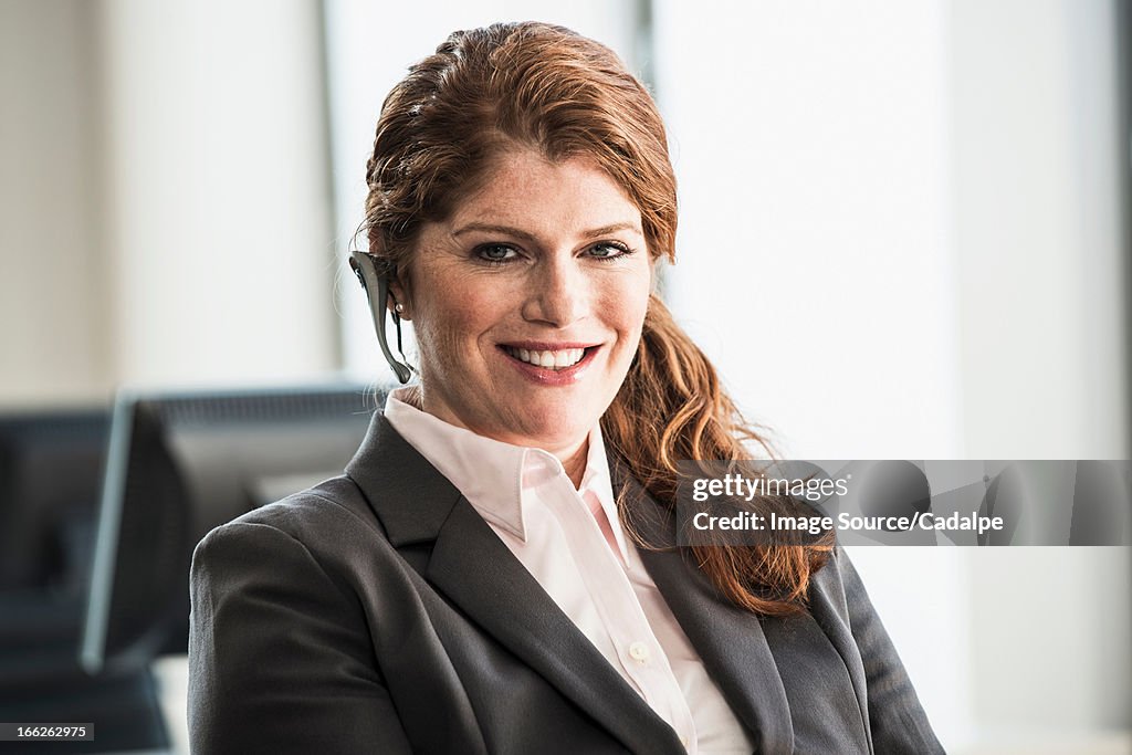 Smiling businesswoman wearing headset