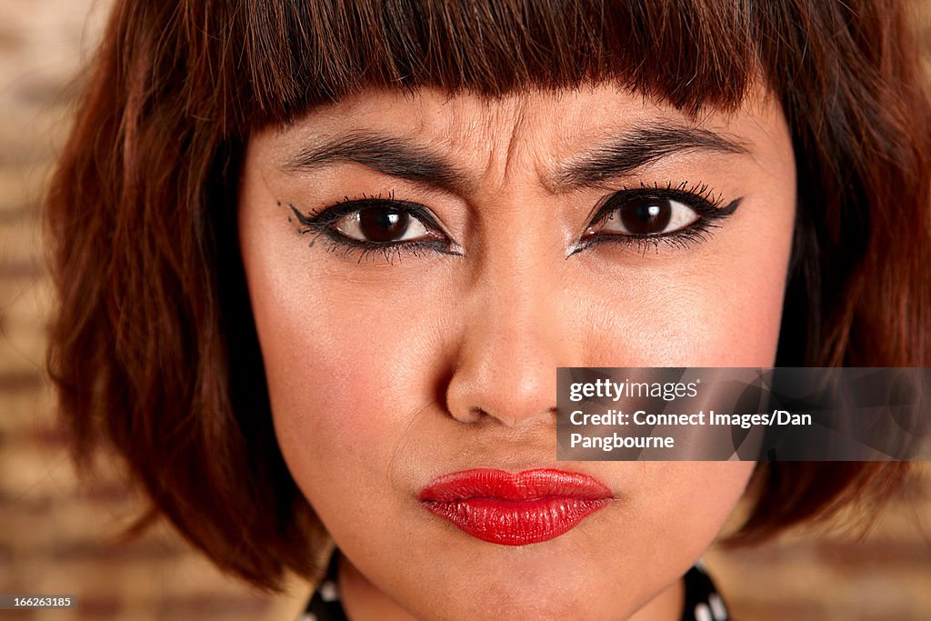 Close up of woman's frowning face