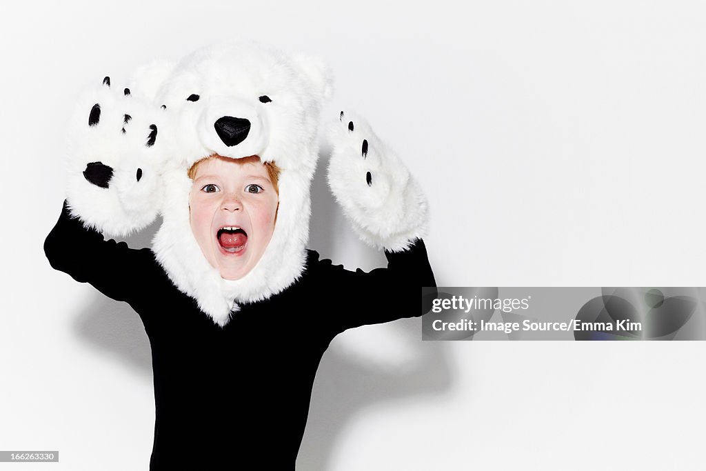 Boy wearing bear head and claws