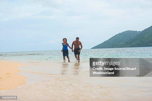 couple walking on tropical beach - fiji smiling stock pictures, royalty-free photos & images