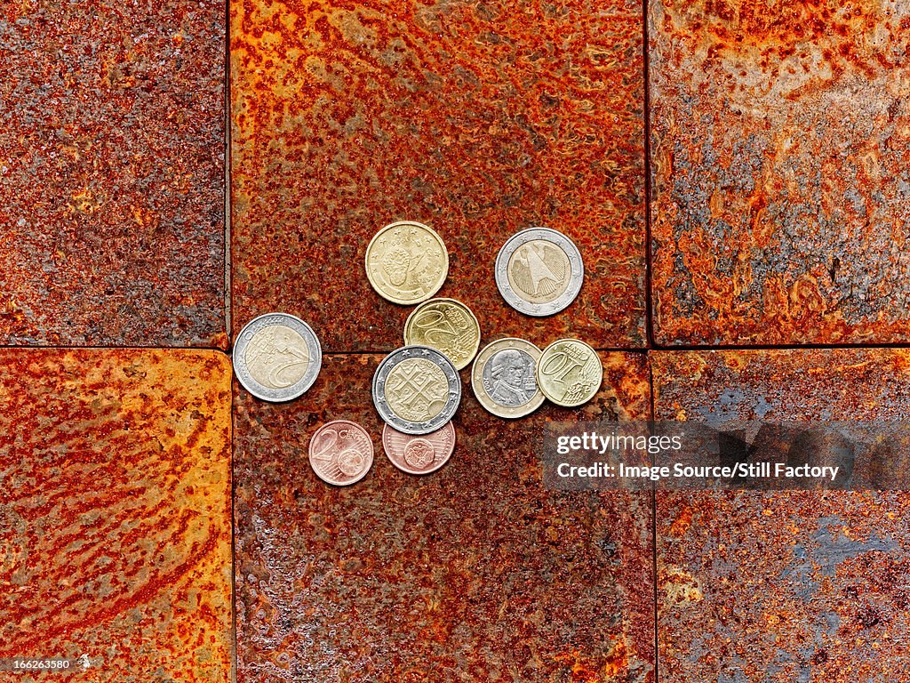 Euro coins on brick floor