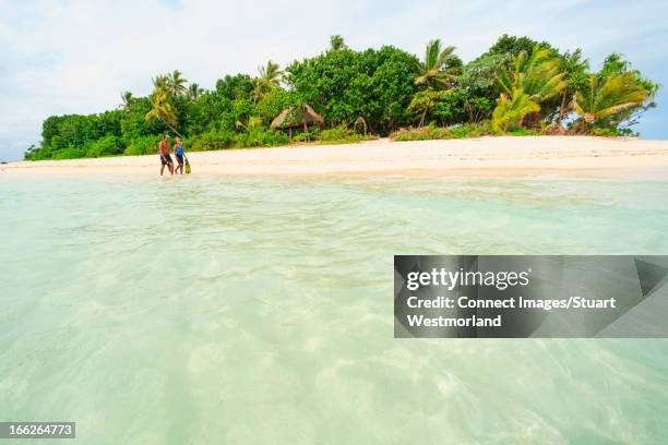 couple walking on tropical beach - south pacific stock pictures, royalty-free photos & images