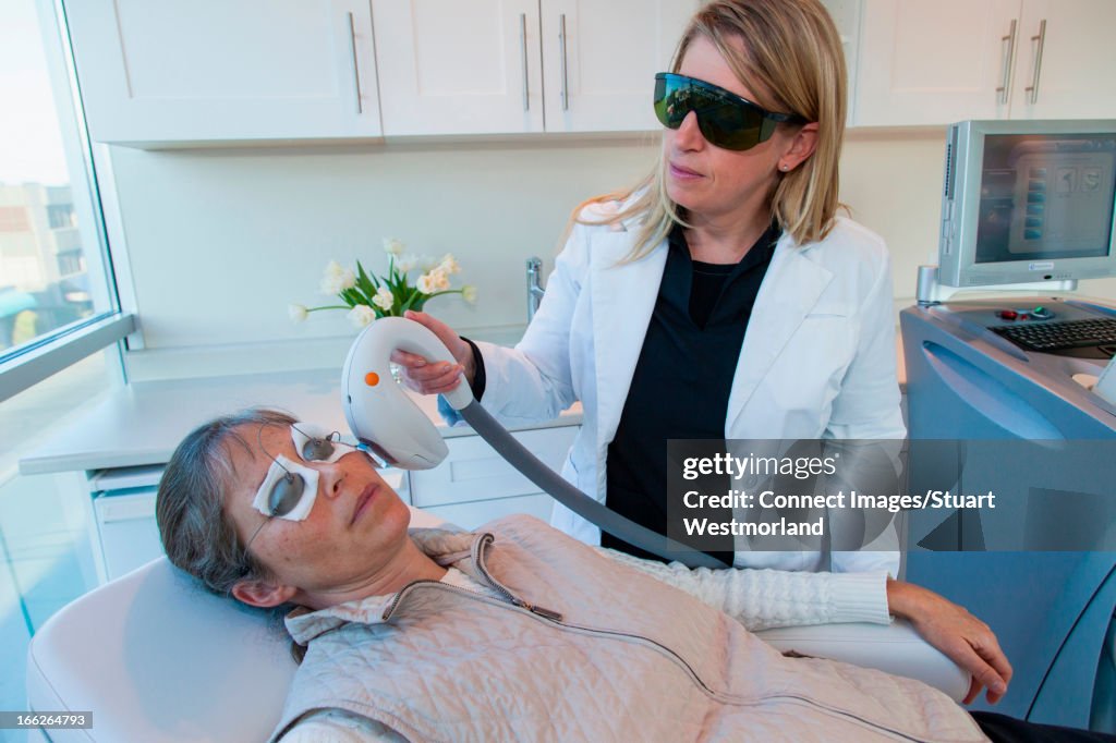 Doctor giving patient sunspot treatment