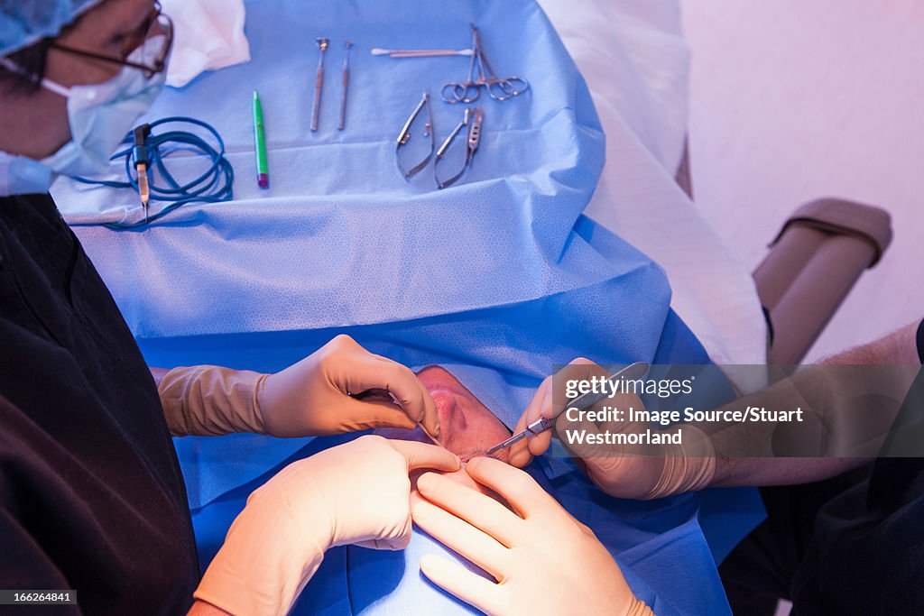 Surgeons with patient in operating room