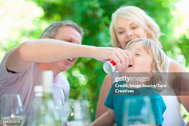 father giving son soda at table - stellenbosch wine bildbanksfoton och bilder