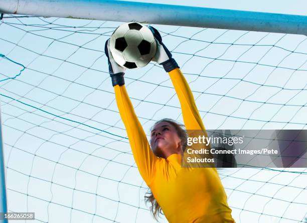 soccer player catching ball in goal - goalkeeper gloves stock pictures, royalty-free photos & images