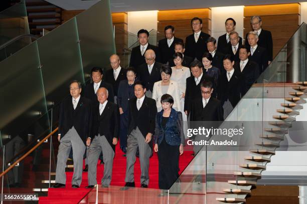 Japanese Prime Minister Fumio Kishida walks down stairs with his new cabinet members at the prime minister's official residence in Tokyo, Japan, on...