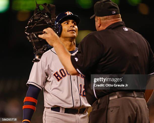 Carlos Pena of the Houston Astros argues a called third strike with home plate umpire Wally Bell in the fifth inning against the Seattle Mariners at...