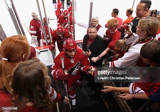 Paul Bissonnette of the Phoenix Coyotes is greeted by fans as he leaves the ice following the NHL game against the Detroit Red Wings at Jobing.com...