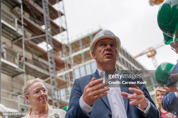 Berlin Governing Mayor Kai Wegner views a public housing construction project of degobau, one of several property companies owned by the city, during...