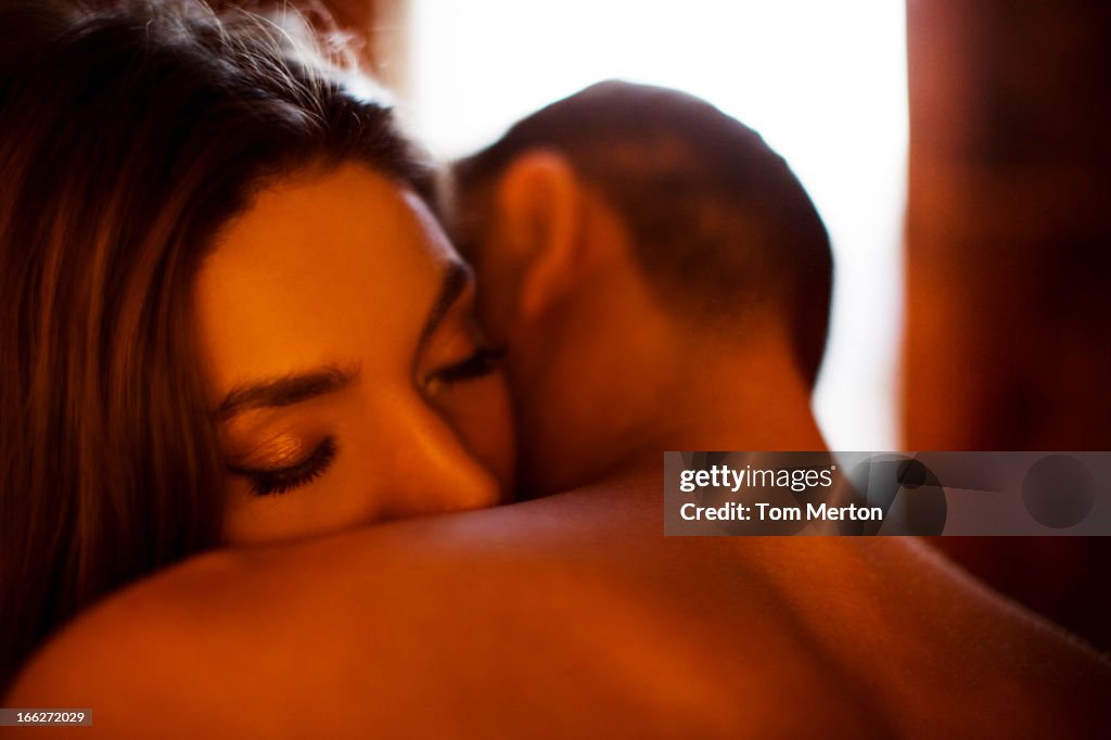 Couple kissing in bedroom